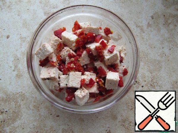 Combine pepper, onion, dried tomatoes, drizzle with lemon juice, add salt, tofu, and mix.