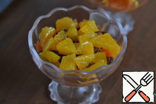 Put the orange slices on the raisins.