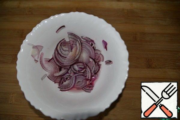 red onion cut into thin half rings, add salt, sugar, vinegar and leave to marinate for 15 minutes.