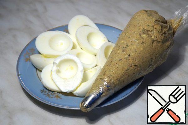 The resulting mass is stuffed with egg halves.
