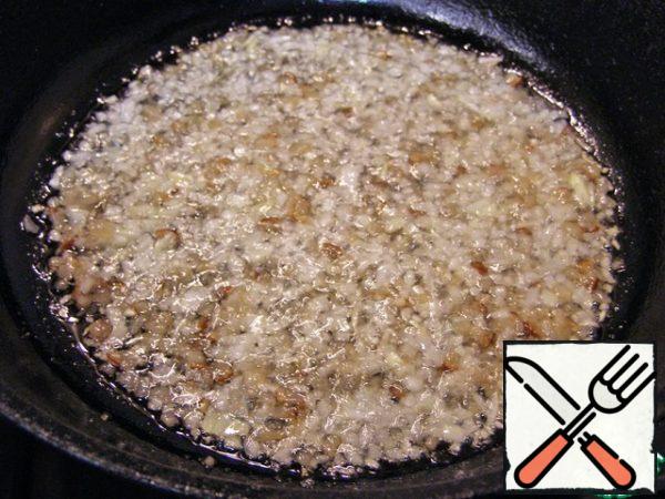 Preheat a frying pan and fry the lard with onions on low heat until translucent.