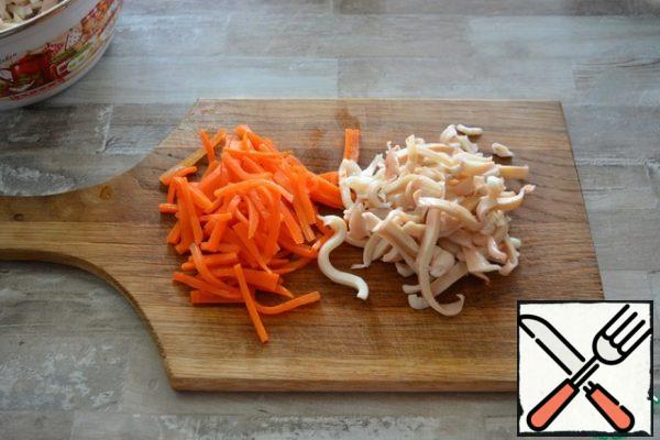 cut the boiled carrots and boiled squid into strips.a little secret: the easiest way is to cut raw carrots into strips, then throw them into boiling water with a pinch of salt and sugar and boil for 7-8 minutes until soft, then flip them into a colander and let cool. this carrot is much tastier in a salad and looks better.