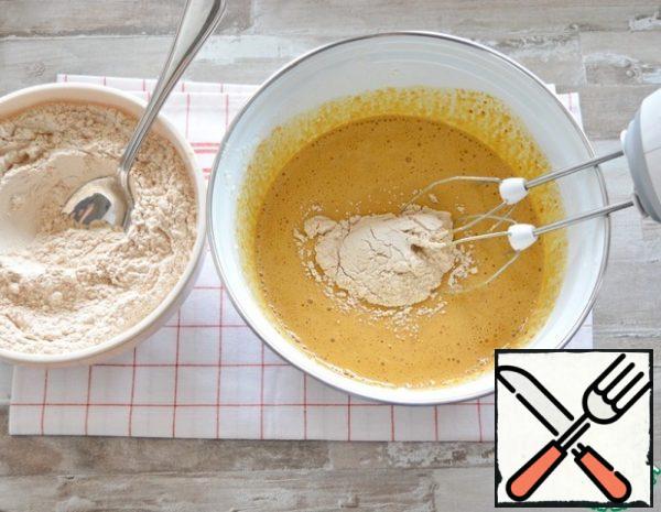 Now, at low speed of the mixer, gradually introduce the flour mixture into the liquid ingredients.