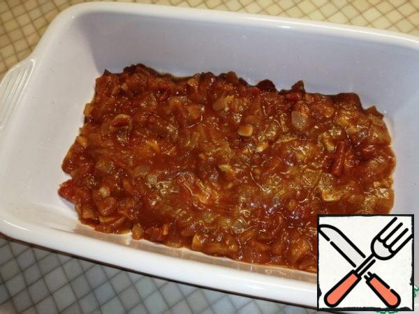 Put the tomato sauce in the baking dish. Since the rings are large, I use two shapes.