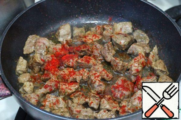 Add the meat to the pan where the bacon was fried and fry the meat on high heat until Golden brown. You do not need to add additional oil, just the fat that was melted from the bacon is enough. Then add sweet paprika, add salt and ground black pepper to taste.
