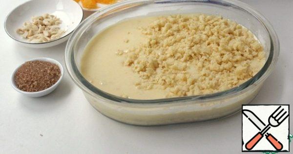 Put the curd filling on top of the crumbs and cover with the second half of the flour mixture.