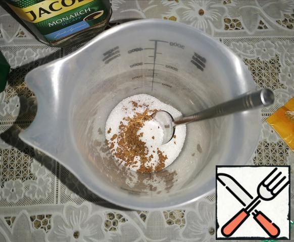 Pour boiling water over the sugar, instant coffee and vanilla sugar and mix.* Adjust the amount of sugar and coffee to your taste.