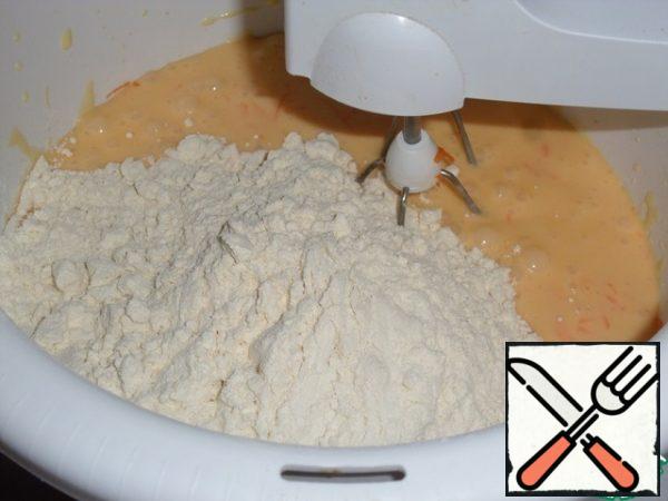 Add the flour sifted with baking powder to the bowl.
