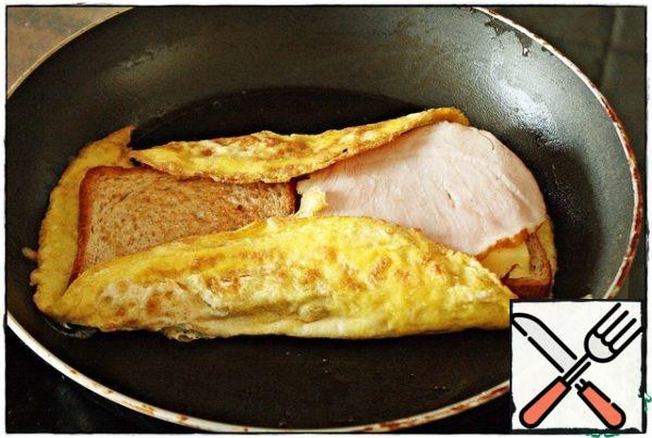 Again folded around the edges of the omelet with a spatula pressing.