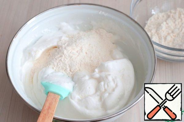 Then add flour (150 gr.) with baking powder. Knead the mixture, then add the milk (50 gr.). And knead well again. Cover the bowl with the protein dough with a towel and set aside.