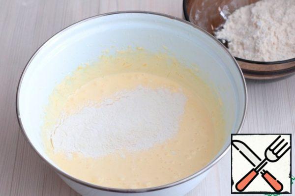 Then add flour (150 gr.) with baking powder (4 gr.) in portions.