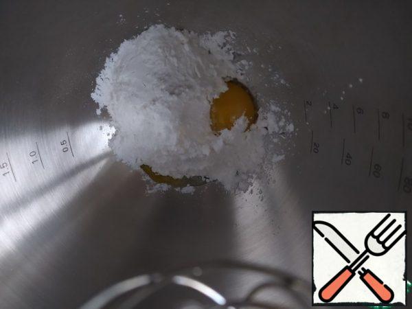 Prepare the cheese part: beat the yolks with powdered sugar into a strong foam.