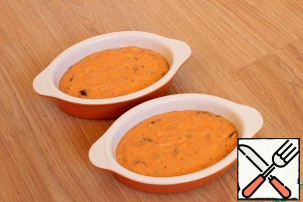 I take 2 small baking pans, grease with butter. i pour the dough into them.