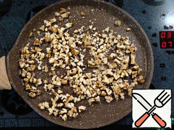 Finely chop the walnuts and lightly fry in a dry pan.
