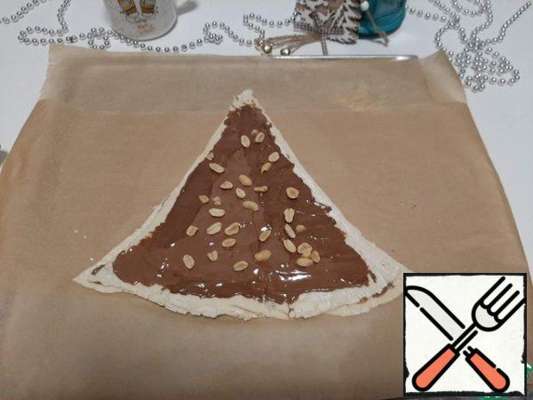 Again grease with chocolate and sprinkle with peanuts.