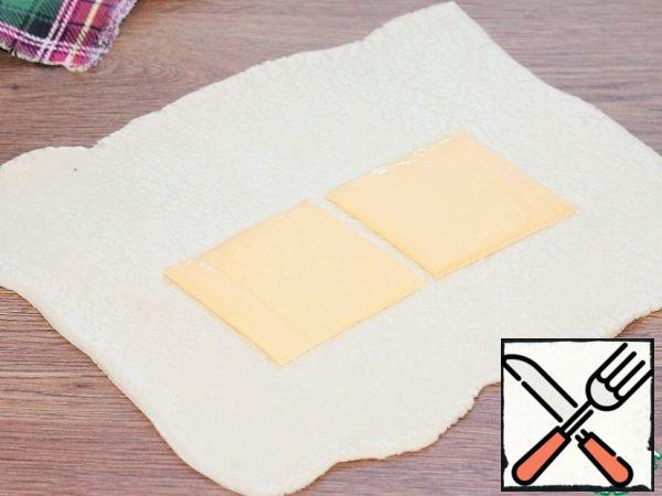 Put 2 plates of melted cheese on the dough.