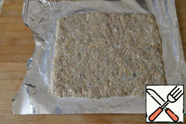 Take the foil, fold the sheet twice. Lubricate with oil. We distribute the minced meat with a layer of about 1.5 cm on the foil in the form of a rectangle.