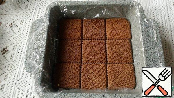 Form the size of 19 × 19 cm cover with film. Place the cookies with a flat surface facing down.