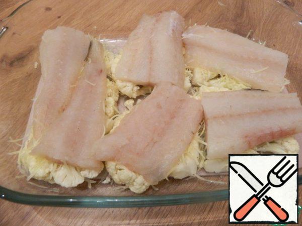 Put the fish on top. Season with salt and pepper.