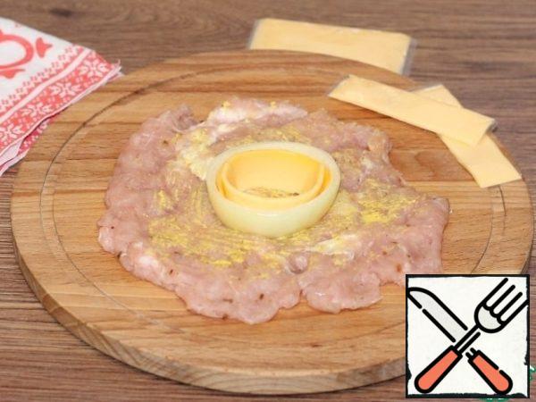 Cut the plate cheese into strips and put it in an onion ring.