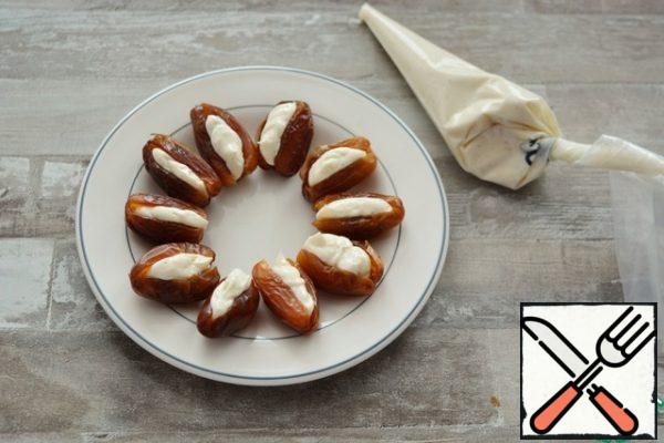 using a pastry bag, stuff the dates with melted cheese.
It took me 25 dates.