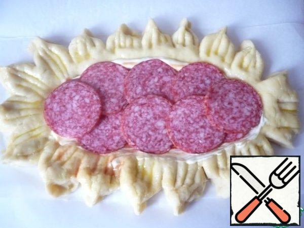Put thinly sliced sausage on the ketchup (I have smoked sausage).
