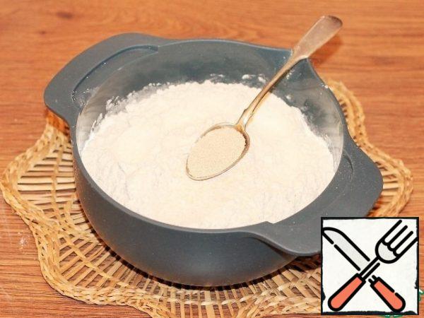 Mix 2/3 of the flour with dry yeast and mix with a whisk.