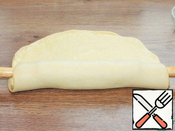 Roll two layers of dough on a rolling pin.
