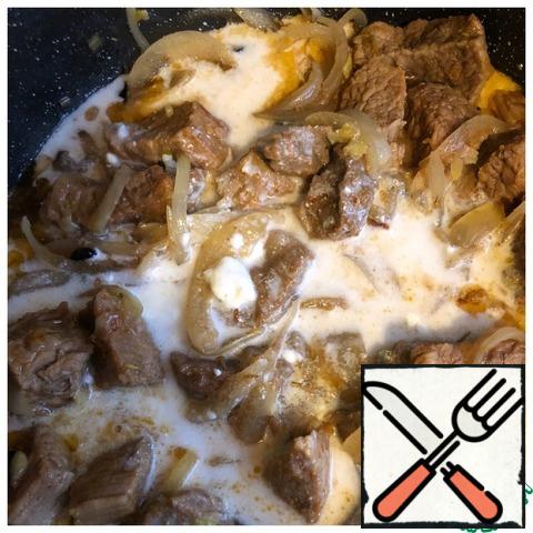 Pour the curd filling to the meat, mix and leave to simmer for another 15-20 minutes. Serve the meat with your favorite side dish.
