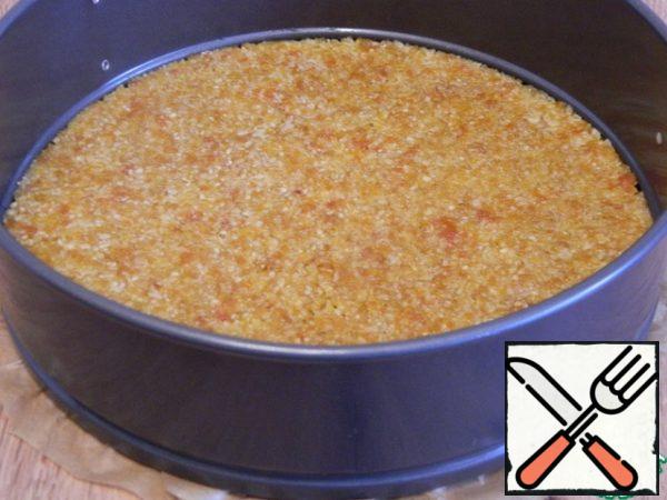 Put the dough of the cake in a split form of 18 mm, seal the mass with a pusher. Put in a preheated oven to 180 degrees and bake the cake for 15-20 minutes