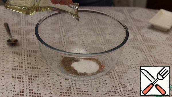 In a large bowl, mix the seasonings, salt and oil. It will be a marinade.
