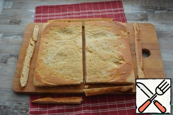 Remove the parchment, flatten the cake and cut into 2 pieces.

In principle, you can bake in a standard split form, then cut into 2 cakes.