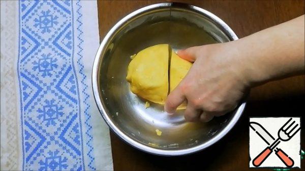 We collect the dough into a ball, divide it into two parts. Wrap with cling film and send to the refrigerator for about 1 hour.