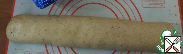 In two or three steps, pour the flour into the egg-oil mixture. Knead a soft elastic dough. Roll a sausage 20 cm long from the dough. Wrap in plastic wrap. Place in the refrigerator for 30 minutes.