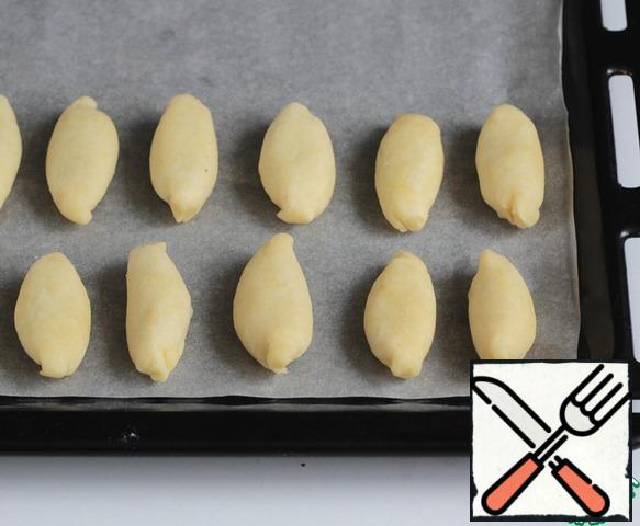 Place on a baking sheet, seam down.
Repeat the same with the remaining dough.