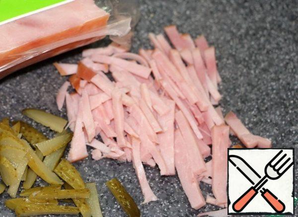For the filling, cut the pickled cucumber and ham into strips .