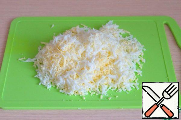 Boil the eggs, grate them on a fine grater.