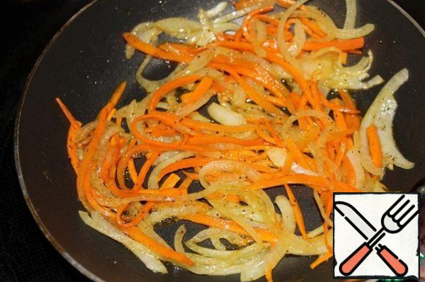 Cut the onion into half rings, cut the carrots into thin strips, and fry until slightly golden brown. Cool down.