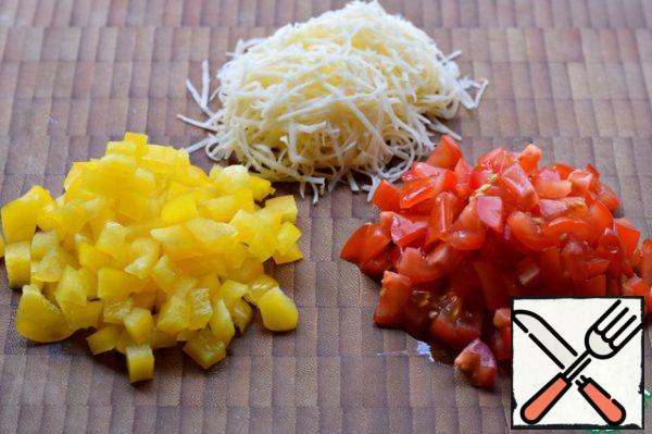 Grate the cheese on a fine grater. Cut the tomatoes and peppers into small cubes.