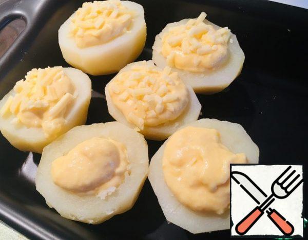 Fill the potatoes with the filling, sprinkle the remaining cheese on top.