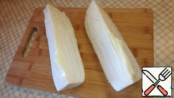 Peking cabbage cut into quarters, I prefer large, so I buy a large cabbage. Place on a large plate or bowl.