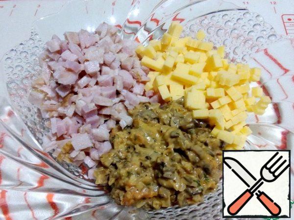 Cut ham and hard cheese into small cubes, add the mushroom mixture to them, mix everything together.