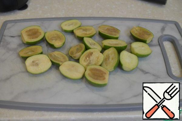 Wash the feijoa, dry it, and cut it into halves.