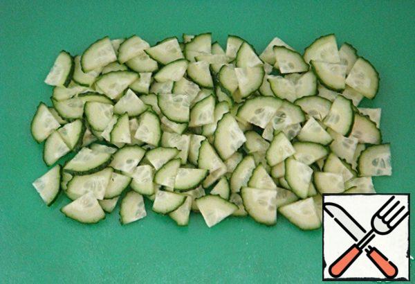 Cut the cucumbers lengthwise into four pieces, then crosswise into thin slices.