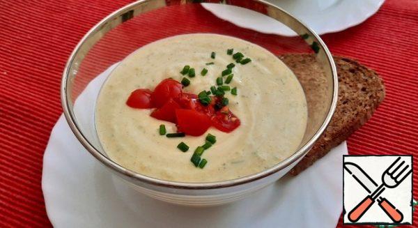 Pour the soup into deep plates, decorate with chopped tomatoes and herbs.