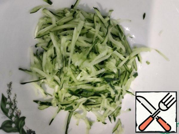 We grate the cucumber on a grater for Korean carrots.