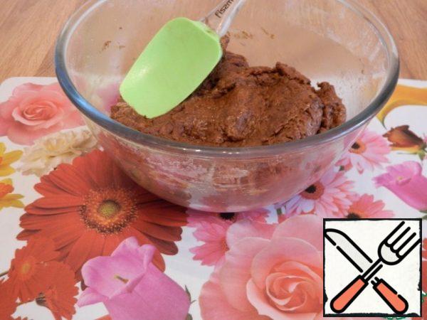 The dough is quite thick, stir it well with a spatula. And only after that add 100 ml of boiling water, stir well.