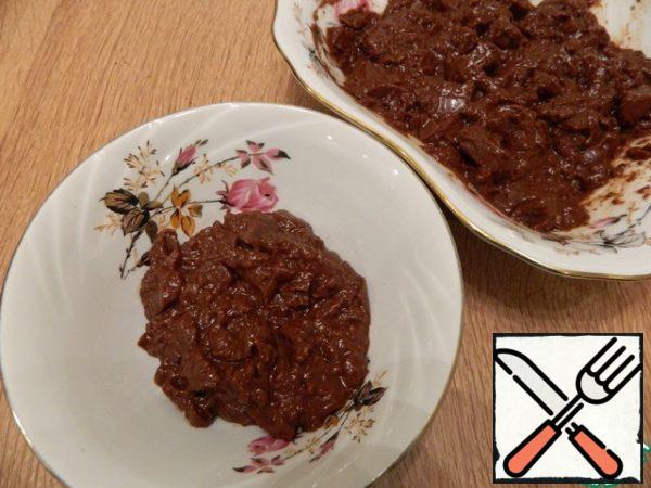 Break it slightly with the end of the spatula. Divide it into 2 parts. A smaller part will be required for the top and sides of the cake.