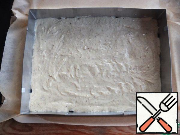 In a baking sheet covered with baking paper, spread the dough and level it. For convenience, I used a split form - 35*25 cm.
Bake in a preheated 180 degree oven for 15-20 minutes.