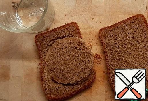Cut out the bread with a glass of mugs.